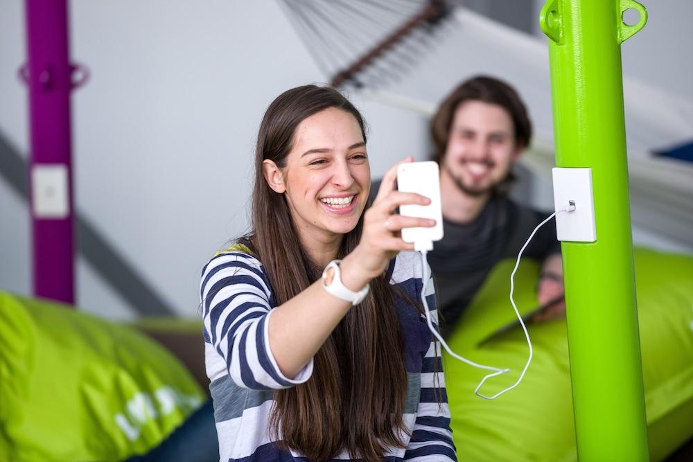Lylo Christchurch Exteriör bild A student using a mobile phone at the University of Applied Sciences and Medical University of Southern Tyrol